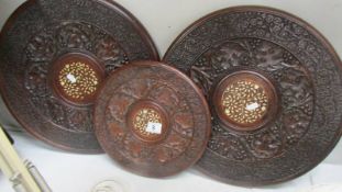 Three oriental carved table tops.