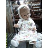 A large vintage doll with celluloid head, glass eyes, eye lashes & voice box, no visible makers mark