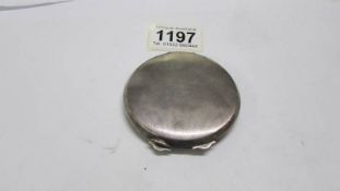 A silver powder compact.