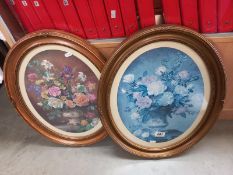 A pair of oval framed prints of flowers (43cm x 54cm)