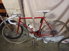 A red & white Peugeot racing bike