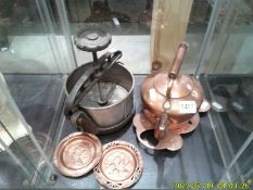 A copper kettle, a brass trivet, 2 brass pin trays and an old tongue press.