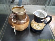 A Doulton Lambeth harvest jug and a Doulton Langley jug.