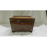 A 19th century mahogany tea caddy inlaid with mother of pearl.