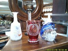 A pair of glass vases, a red etched vase, candlestick and paperweight.