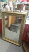 A large gilt framed bevel edged mirror. COLLECT ONLY.