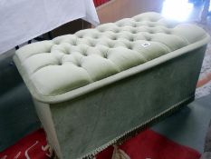 A fabric covered ottoman