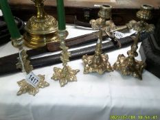 Two pairs of decorative brass candlesticks.