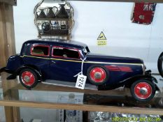 A large tin plate clockwork 1930's style car with opening doors and boot, 50 cm long.