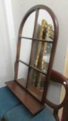 A mahogany framed arched top mirror with shelf. COLLECT ONLY.