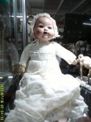 An early Chad Valley baby doll with bisque head, moving eyes and voice box.
