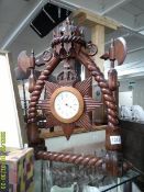 An unusual carved wood mantel clock.