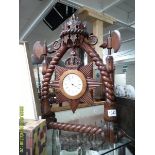 An unusual carved wood mantel clock.