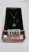 An Edwardian drop pendant necklace set blue stones, stamped 9ct.