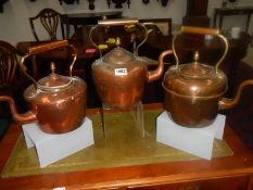 Three Victorian copper kettles.