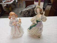 A pair of Doulton figures