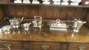 A silver plate tea set, toast rack, tureen and coffee pot.