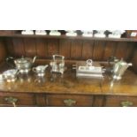 A silver plate tea set, toast rack, tureen and coffee pot.