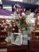 A vase full of artificial flowers and cake ornaments