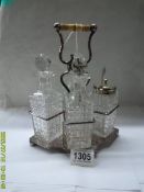 A four bottle condiment set on silver plate stand.