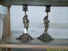 A pair of bronze figural candle sticks.