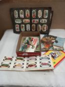 An album of cigarette cards and a quantity of tea cards in albums.