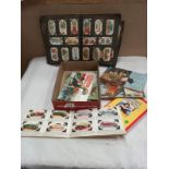 An album of cigarette cards and a quantity of tea cards in albums.