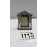 A miniature silver photo frame, 5 x 4 cm.