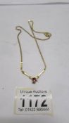 A ruby and diamond pendant with attached chain, stamped 10ct gold.