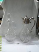 A cut glass claret jug with silver plate top (top loose) and another cut glass claret jug.