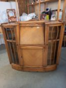 An Edwardian oak cabinet