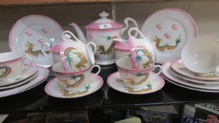 An oriental 'Imoto' hand painted dragon tea set with Geisha in cup bottoms.