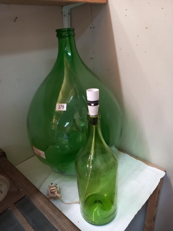 A large green glass Carboy and another large Martell Cognac bottle converted to a lamp