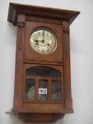 A 1930's oak wall clock. COLLECT ONLY.