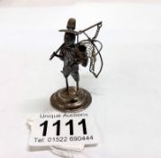 A miniature silver fisherman with basket.