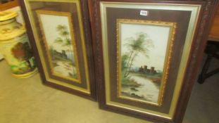 A pair of framed and glazed paintings on opaque glass signed. COLLECT ONLY.