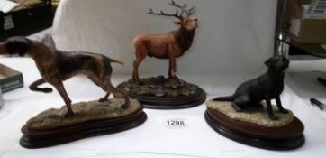 A Country Artist Stag and two unmarked dog figures.