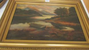 A gilt framed oil on canvas mountain and lake scene.