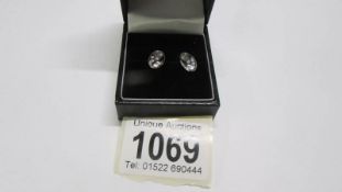 A pair of 9ct gold diamond stud earrings.