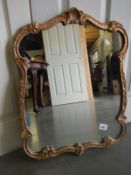 An ormalu style gilt framed mirror