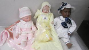 An Ashton Drake Newborn baby doll and two others.