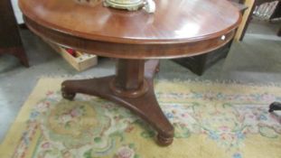 A circular mahogany dining table. COLLECT ONLY.