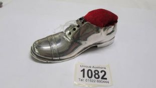 A large silver shoe pin cushion.