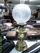 A brass oil lamp with etched glass shade. COLLECT ONLY.