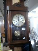 A small oak wall clock.