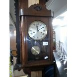 A small oak wall clock.