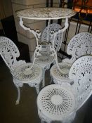 A decorative white painted cast garden table and four chairs, COLLECT ONLY.