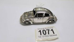 A silver Volkswagen car, 71.8 grams.