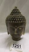 A brass/bronze Buddha head.