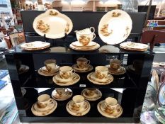 3 shelves of Alfred Meakin farming scene tableware, mainly cup and saucer trios